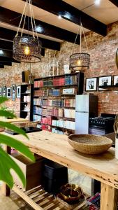 a library with a wooden table with books on it at 007 Loft in Mossel Bay