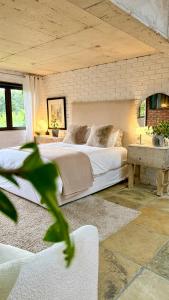 a bedroom with a large bed and a table at 007 Loft in Mossel Bay