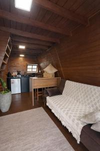 a bedroom with a bed and a desk in a room at Cabanas Farol in Pântano Grande