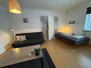 a living room with a couch and a table at Two room warm apartment Östavall in Östavall