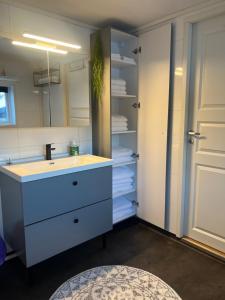 a bathroom with a sink and a mirror and towels at My Home Kaldfjorden in Tromsø +58 photos