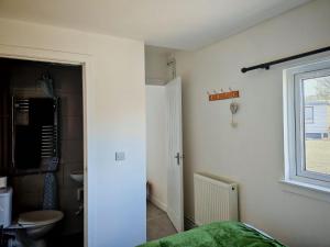 a bedroom with a bed and a sink and a window at Half Pint in Tain