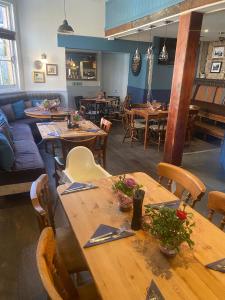 a dining room with wooden tables and chairs at The Phelips Arms in Montacute