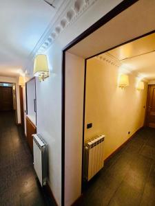 a hallway of a building with a mirror and two radiators at Beauty Rooms in Rome