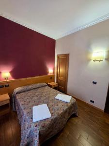 a bedroom with a bed with two towels on it at Beauty Rooms in Rome