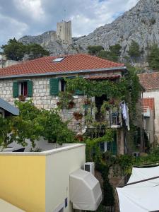 a building with a mountain in the background at Ankora in Omiš +13 photos