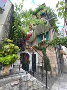 a stone building with a black iron gate at Ankora in Omiš