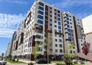 a large white apartment building on a city street at Privat Apartment Ciocana in Chişinău