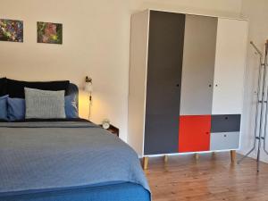a bedroom with a bed and a large cabinet at Ferienwohnung Vogelnest mit weitem Blick über den Schwarzwald in Baiersbronn
