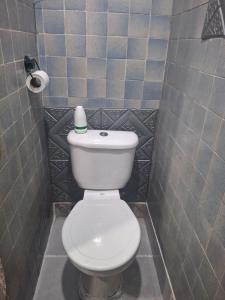 a bathroom with a white toilet in a stall at Backpacker's ROOF in San Salvador +11 photos