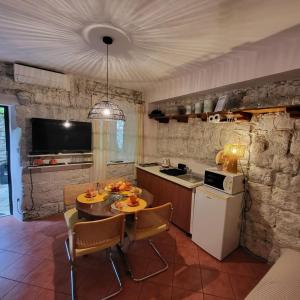 a kitchen with a table and chairs in a room at Ankora in Omiš