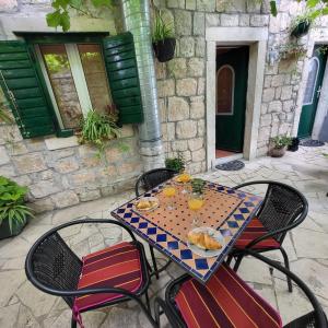 a table and chairs with a plate of food on it at Ankora in Omiš