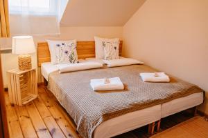a bedroom with two beds with towels on them at tuŻur domki nad potokiem in Osie +58 photos
