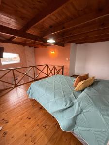 a large bed in a room with a wooden floor at Ana rent Ballester departamentos modernos luminosos, equipados para una hermosa estadia in Villa Ballester