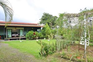a house with a garden in front of it at Volcano Garden Suite with Hottub in Palma