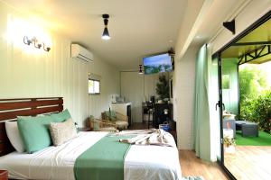 a bedroom with a bed and a tv on the wall at Volcano Garden Suite with Hottub in Palma