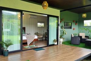 a room with a sliding glass door with a bedroom at Volcano Garden Suite with Hottub in Palma