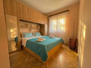 a bedroom with a bed with two towels on it at Apartment Novi II in Kaštela +12 photos