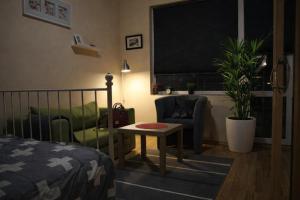 a bedroom with a bed and a chair and a table at Apartment 132 in Sofia