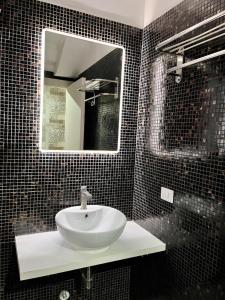 a bathroom with a white sink and a mirror at Beauty Holidays in Rome +10 photos