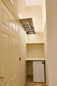 a laundry room with a shelf and a light at Tiare' in Trani