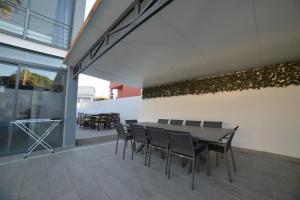 a patio with a table and chairs in a building at Villa Alvor in Alvor