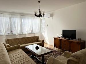 a living room with two couches and a tv at Relax Visoko Apartman in Visoko