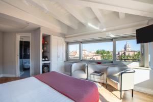 a bedroom with a bed and two chairs and a window at Hotel La Rovere in Rome +87 photos