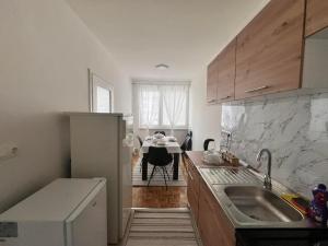 a kitchen with a sink and a counter top at Relax Visoko Apartman in Visoko