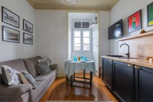a living room with a couch and a table at Casa de Santa Rita in Chaves