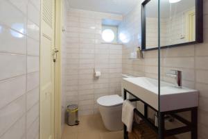 a white bathroom with a sink and a toilet at Casa de Santa Rita in Chaves
