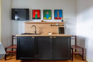 a kitchen with a counter with a sink and a tv at Casa de Santa Rita in Chaves +9 photos