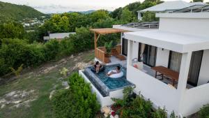 two people sitting in a pool in the backyard of a house at Coolidge Cottages in Osbourn +10 photos