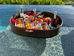 a basket of food and wine on top of the water at Coolidge Cottages in Osbourn