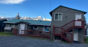 a house with a staircase and a deck at Halibut House Unit 3 in Seward