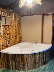 a bath tub in a bathroom with a chandelier at Los Pinos EcoHotel in Villa Restrepo