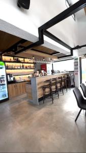 a restaurant with chairs and a counter with a bar at Poiana Events - Vilă privată cu piscină aproape de Mamaia și Constanța in Poiana