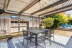 a patio with a table and chairs on a deck at Spacious 4BR Backyard Oasis with BBQ Near UC Davis in Davis