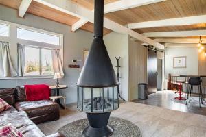 a living room with a fireplace in the middle at Spacious 4BR Backyard Oasis with BBQ Near UC Davis in Davis