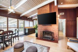 a living room with a fireplace and a flat screen tv at Spacious 4BR Backyard Oasis with BBQ Near UC Davis in Davis
