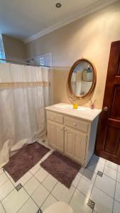 a bathroom with a sink and a mirror on the wall at 1 Bed Apt overlooking Rodney Bay in Gros Islet +6 photos