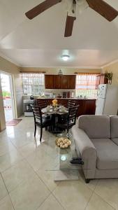 a kitchen and living room with a table and a couch at 1 Bed Apt overlooking Rodney Bay in Gros Islet