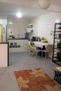 a kitchen with a table and chairs in a room at Casa de Mainha in Salvador