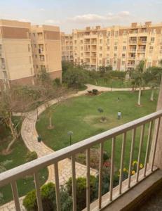 a view of a park from a balcony of a building at Rest and relaxation in Madinaty