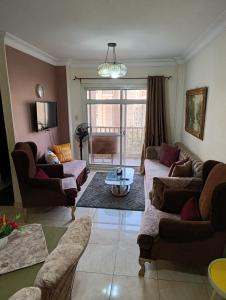 a living room with couches and a table at Rest and relaxation in Madinaty