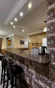 a kitchen with a stone counter with bar stools at Rest and relaxation in Madinaty