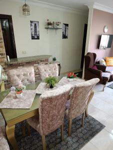a dining room with a table and chairs at Rest and relaxation in Madinaty +2 photos