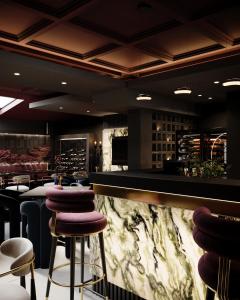 a bar with purple stools in a restaurant at Hotel Bela Kuka - White House in Bitola