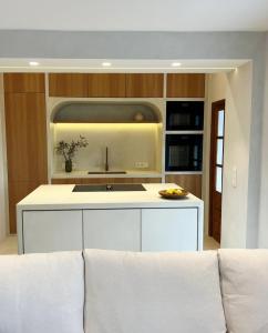 a kitchen with a white couch in a room at Casa Mimo Altea in Altea