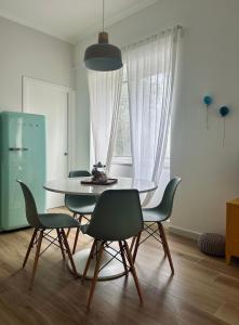 a dining room with a table and four chairs at Blu Bolivar in Marina di Camerota